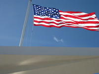 The flag over the USS Arizona Memorial.